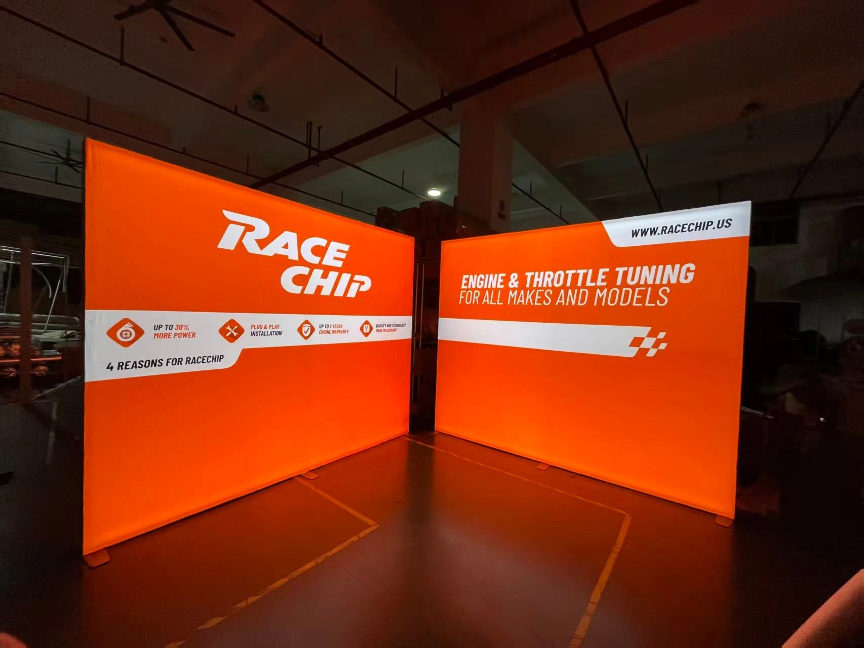 RaceChip L-shaped orange backdrop booth at SEMA