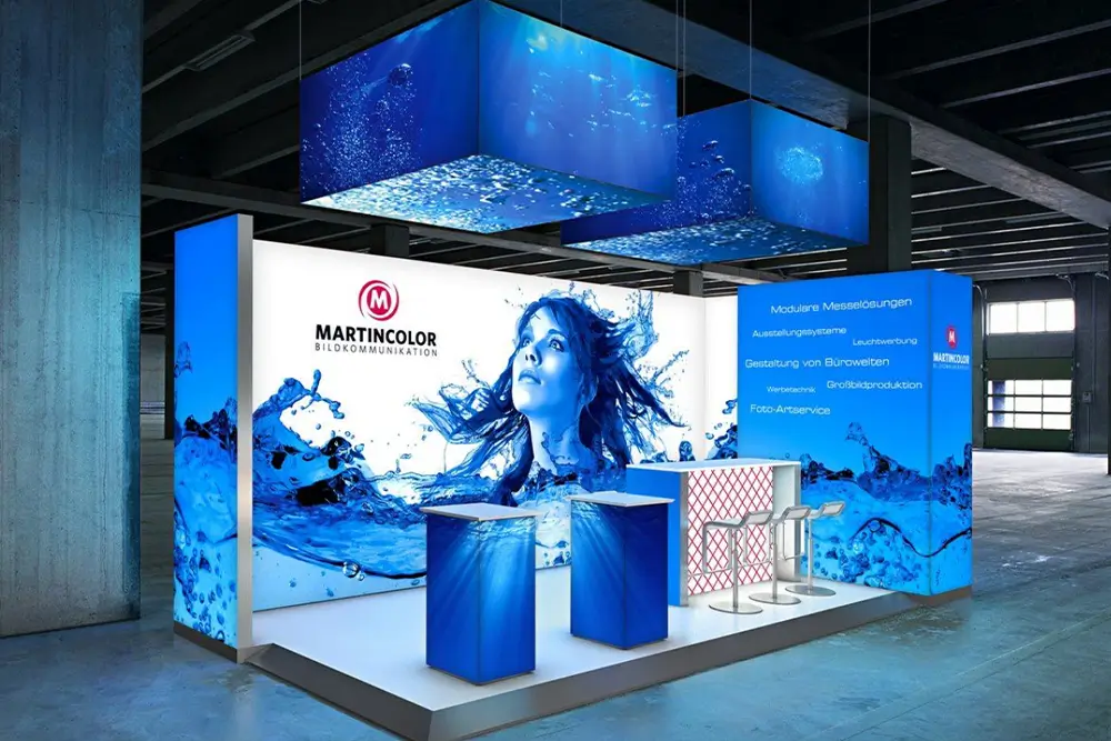 Modular illuminated conference display with branded walls, hanging elements and reception counters