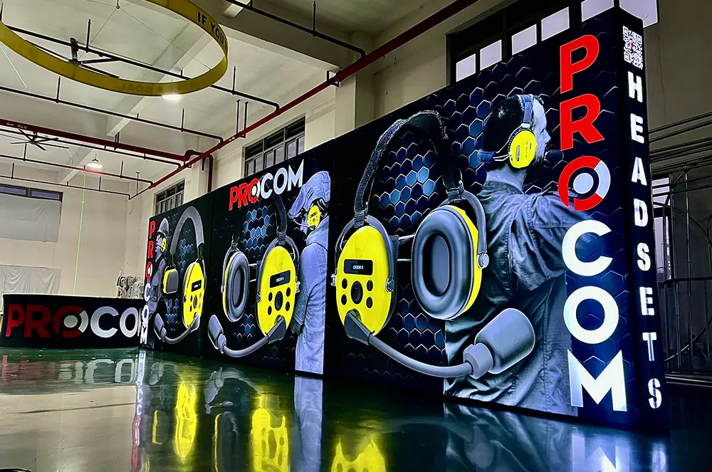 Large conference media wall with illuminated graphics and a wide branded presentation surface