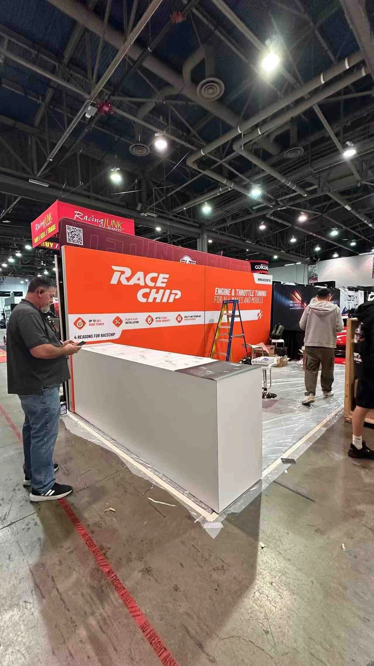 RaceChip illuminated L-shaped exhibition backdrop at SEMA